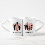 Mr and Mrs Rose Gold Heart Monogram Coffee Mug Set<br><div class="desc">This elegant couples mug set features Mr. and Mrs. in bold brush calligraphy overlaid on soft rose gold hearts with custom last names beneath, all connected by heart-shaped handles. The warm rose gold tone creates a romantic, modern aesthetic. All text is fully editable. A beautiful gift for newlyweds, bridal showers,...</div>
