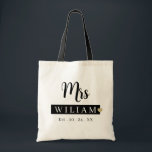 Mrs. Last Name Est Year Tote Bag Personalized Date<br><div class="desc">Modern and chic personalized wedding tote bag featuring elegant black calligraphy “Mrs.” script with custom text that can be updated with the bride’s new last name and special wedding date. A stylish and practical accessory for the bride, perfect for the honeymoon, bachelorette party, wedding day essentials, and everyday use beyond...</div>