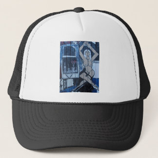 MS VALDEZ NEXT TO WINDOW TRUCKER HAT