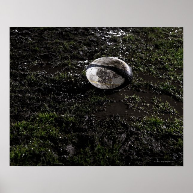 Muddy rugby ball sitting on a chewed up grass poster (Front)