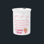 Mug Beverage Pitcher<br><div class="desc">This artwork is a gentle morning greeting designed to bring a smile to a loved one’s face. With soft pink tones, floating hearts, and a cuddly teddy holding a heart, it captures warmth and tenderness. The message, “Good morning, baby. Please wake up and sip today’s already better because you’re in...</div>