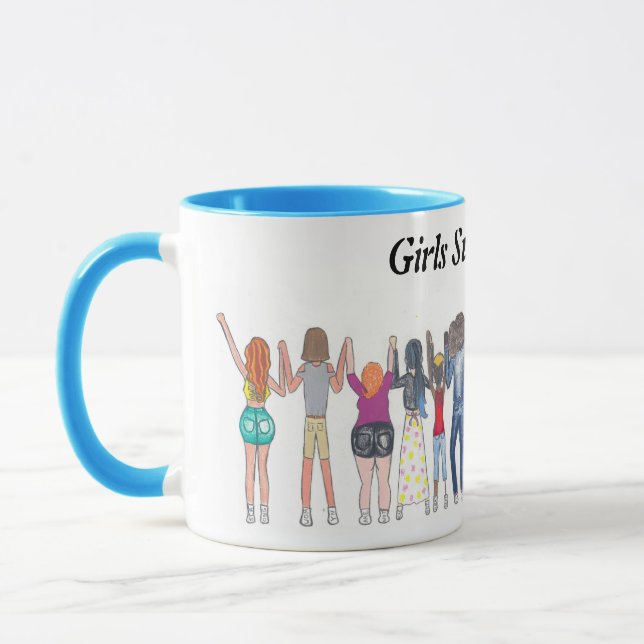 Mug that shows girls supporting each other. (Left)