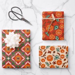 Mulled wine spices, orange slices and holly leaves wrapping paper sheets