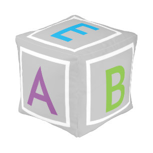 multi colored  ALPHABET  blocks on grey pillow