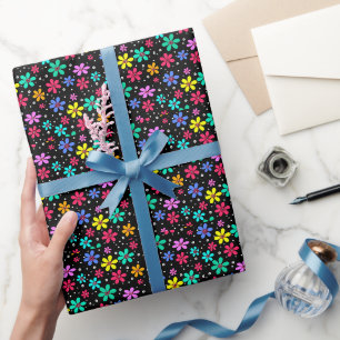 Multi-colored daisies on a black background wrapping paper