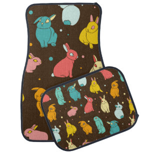 Multi-colored, different rabbits, hares on a dark  car floor mat