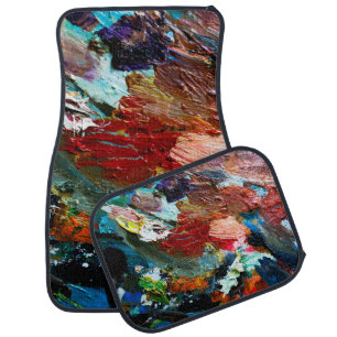 multi-colored strokes of oil paint on the artist's car floor mat