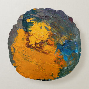multi-colored strokes of oil paint on the artist's round pillow