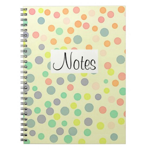 Multicolor dots on pastel yellow notebook