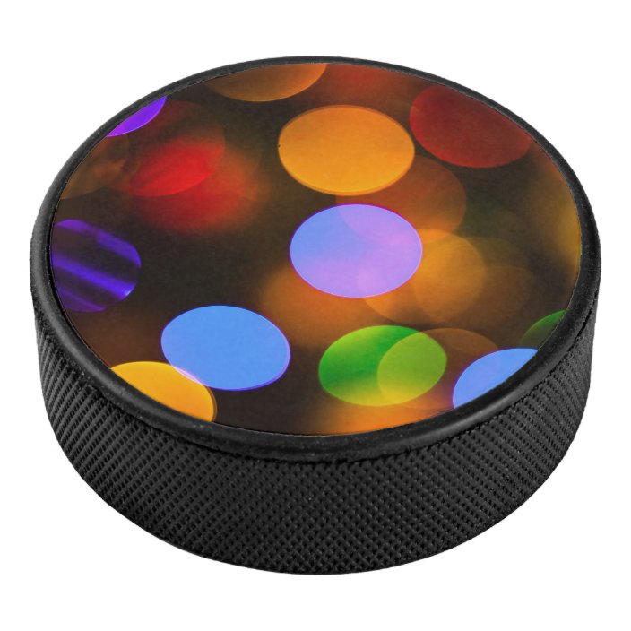 Multicolored Christmas lights. Hockey Puck