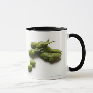 multiple green edamame beans with pea pod broken mug
