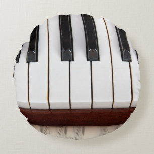 musical notes on the background of a pianoacoustic round pillow