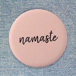 Namaste | Peachy Pink Modern Yoga Meditation Button<br><div class="desc">Simple, stylish "namaste" quote art design in modern minimalist handwritten script typography on a pastel peachy pink background. The slogan can easily be personalized with your own words for a perfect gift for a yoga bunny or pilates lover! Namasté literally means "greetings to you." In the Vedas, namaste mostly occurs...</div>