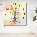Name Monogram Rainbow Tree Square Wall Clock<br><div class="desc">This colourful Wall Clock is decorated with a mosaic tree in the colors of the rainbow on a watercolor background.
Easily customizable with your name or monogram.
Because we create our own artwork you won't find this exact image from other designers.
Original Mosaic and Watercolor © Michele Davies.</div>
