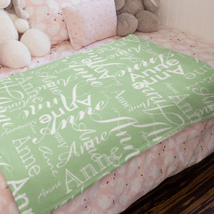 Name Printed in White all-over a Sage Green Baby Blanket
