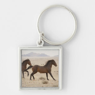 Namibia, Aus. Wild horses running on the Namib Keychain