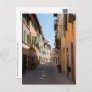 Narrow street with old facades in tuscany village postcard
