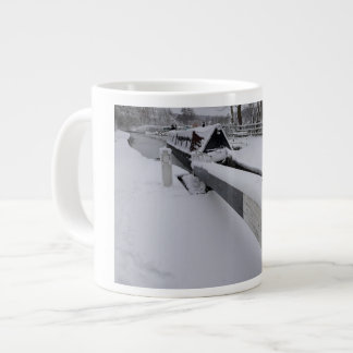 Narrowboat on the canal during a snowy day giant coffee mug