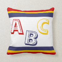 navy blue, yellow, and red ABC on white