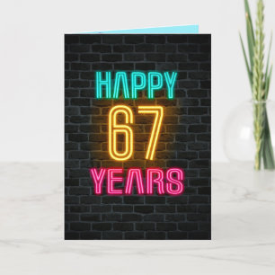 Neon sign on brick for 67th birthday card