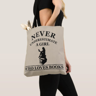 never underestimate a girl who loves books tote bag