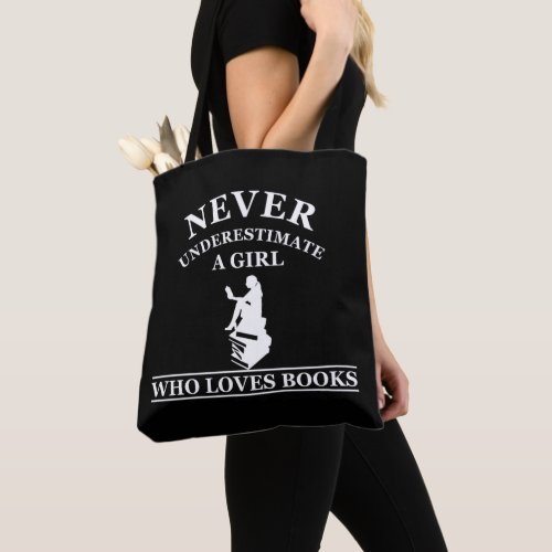 never underestimate a girl who loves books tote bag
