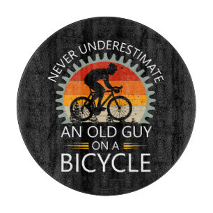 Never Underestimate An Old Guy On A Bicycle Cutting Board