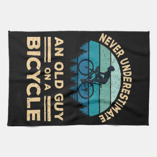Never Underestimate An Old Guy On A Bicycle Funny  Kitchen Towel