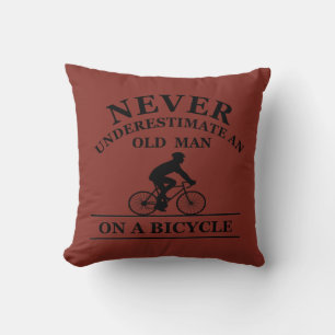 never underestimate an old man on a bicycle throw pillow