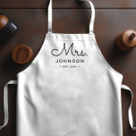 Newlywed Bride Personalized White Apron<br><div class="desc">For the bride and groom, this white apron features "Mrs." in a modern script font along with a last name and established date. This is a perfect bridal shower or wedding gift. These Mrs. and Mr. aprons are available in a variety of colors and can be also customized to match...</div>