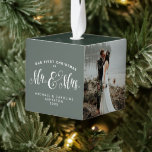 Newlywed first Christmas green Cube Ornament<br><div class="desc">"Our first Christmas as Mr. and Mrs." ornament featuring places for three photos,  plus names and date on a modern green background. Perfect gift to celebrate the newlyweds!</div>