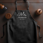 Newlywed Groom Personalized Black Apron<br><div class="desc">For the bride and groom, this black apron features "Mr." in a modern script font along with a last name and established date. This is a perfect bridal shower or wedding gift. These Mr. and Mrs. aprons are available in a variety of colors and can be also customized to match...</div>