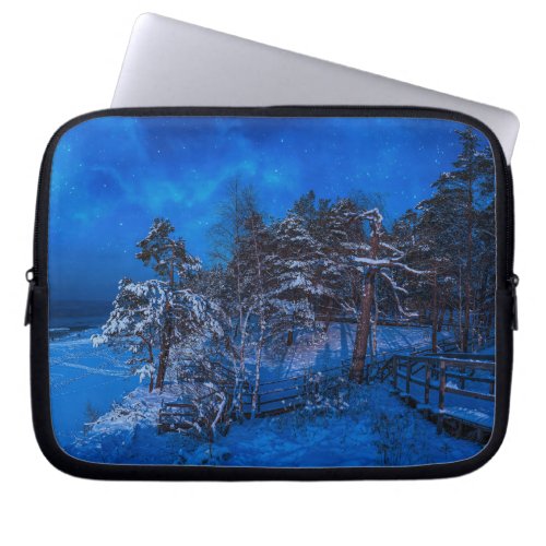 Nighttime winter scene with snow covered pines laptop sleeve
