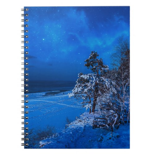 Nighttime winter scene with snow covered pines notebook