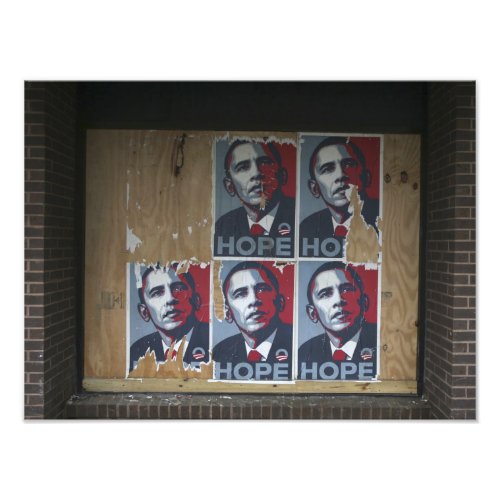 Obama signs in a boarded window of a closed