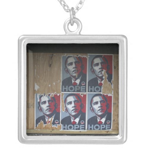 Obama signs in a boarded window of a closed silver plated necklace