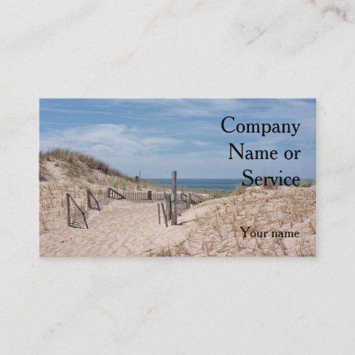 Ocean beach scene with dune fence and sandy path business card
