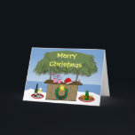 Ocean Beach Tropical Tiki Hut Drinks Christmas Fun Holiday Card<br><div class="desc">This tropical theme has it all - blender drinks, champange and beer on a tray, a santa hat, a holiday wreath with a star, and the beachy tiki hut bar in the sand with the ocean in the background. Merry Christmas is written on the tiki bar roof. A fun island...</div>