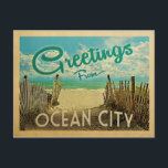 Ocean City Beach Vintage Travel Postcard<br><div class="desc">This Greetings From Ocean City vintage postcard design features a sandy beach with a beautiful turquoise ocean water and above the sea,  a blue sky with billowy white clouds. In vintage travels style.</div>