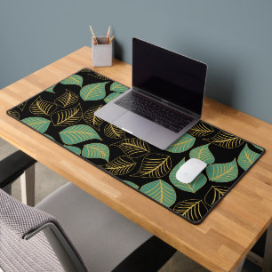 Ocean green and gold broad leaves pattern on black desk mat