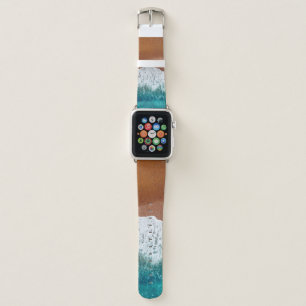 Ocean wave on a sandy beach, background top view apple watch band