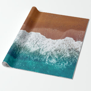 Ocean wave on a sandy beach, background top view wrapping paper