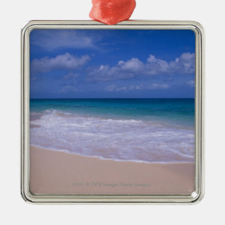 Ocean waves foaming onto sandy beach metal ornament