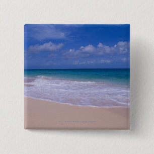 Ocean waves foaming onto sandy beach pinback button