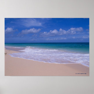 Ocean waves foaming onto sandy beach poster