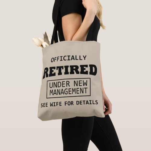 officially retired under new management tote bag