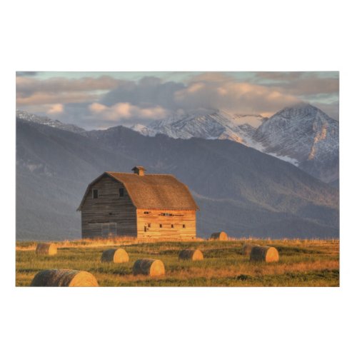 Old barn framed by hay bales and dramatic faux canvas print