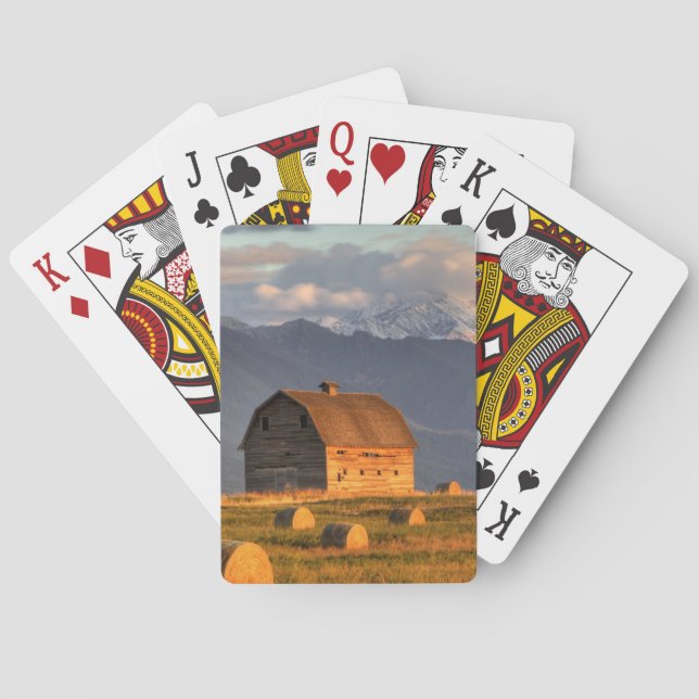 Old barn framed by hay bales and dramatic poker cards (Back)