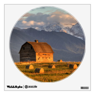 Old barn framed by hay bales and dramatic wall sticker