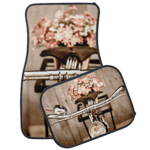Old bicycle and flowers blur in background process car floor mat